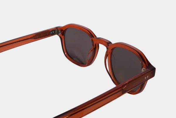 Elevate your style with Frantistek Sunglasses in Rust Orange. Crafted meticulously from sustainable Mazzucchelli bioacetate, these shades redefine eco-luxury. Their classic retro frame transcends trends, embodying timeless elegance. Size: 49mm-23mm, Temple: 145mm. Make a responsible fashion choice and embrace enduring style- side angle